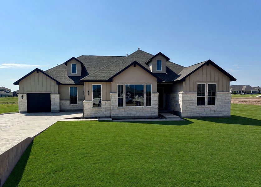 Front exterior of a new home in Leander Estates, Leander, TX, highlighting curb appeal (Image 1). Front exterior of a new home in Leander Estates, Leander, TX, highlighting curb appeal (Image 1).