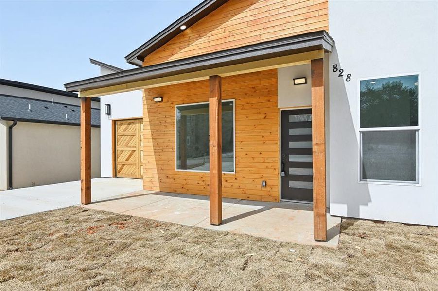 Rear view of property with stucco siding