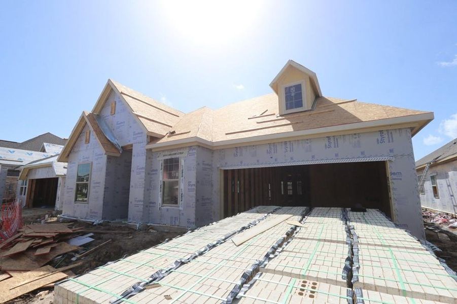 Front exterior of a new home in Meridiana 55' Homesites, Manvel, TX, highlighting curb appeal (Image 2).