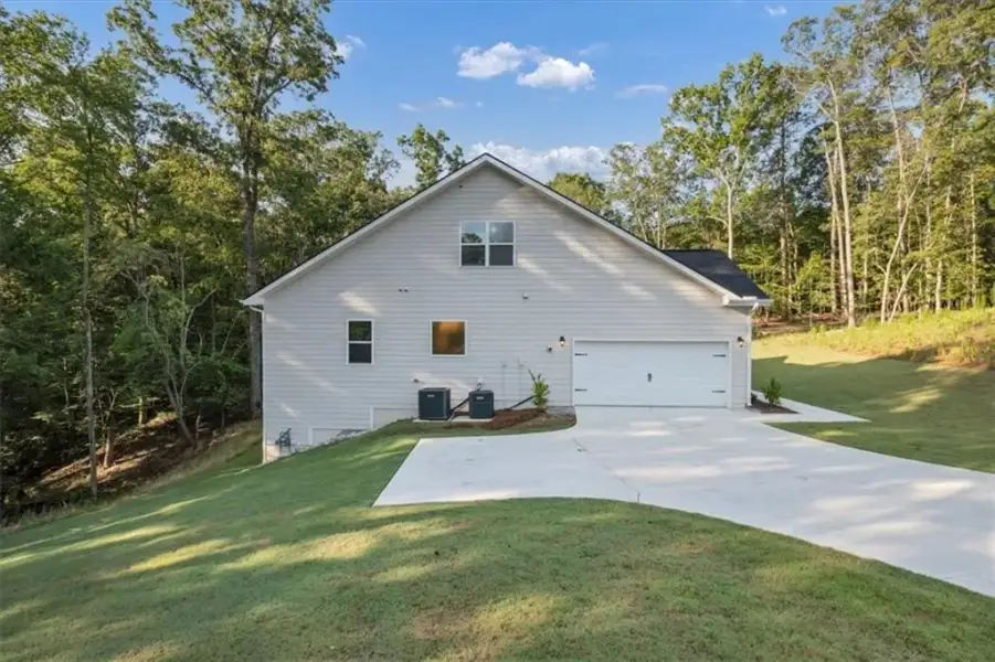 Front exterior of a new home in Tuscany Hills, Douglasville, GA, highlighting curb appeal (Image 26).