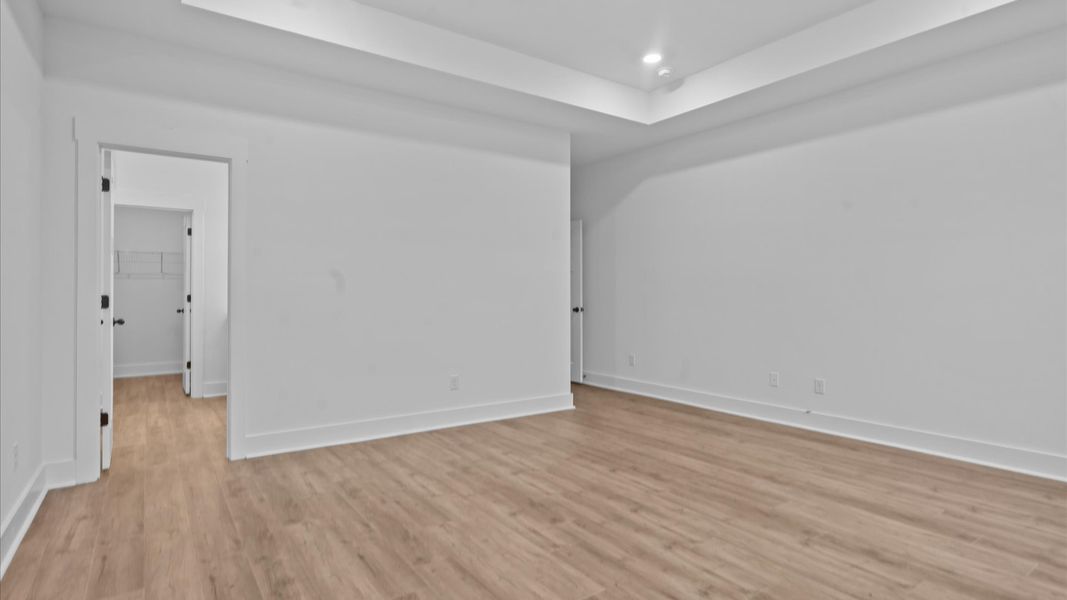 Eye-catching details and elegant finishes in the vibrant primary suite of this select home