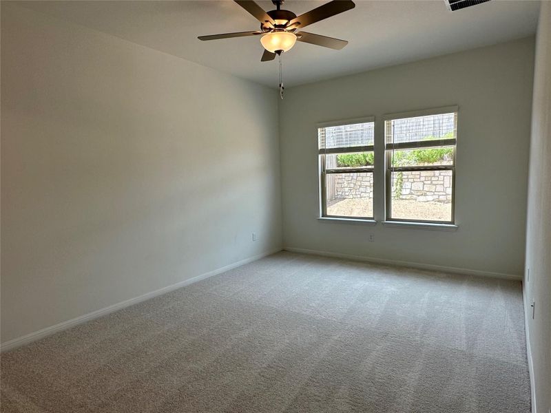 Carpeted empty room with baseboards and ceiling fan
