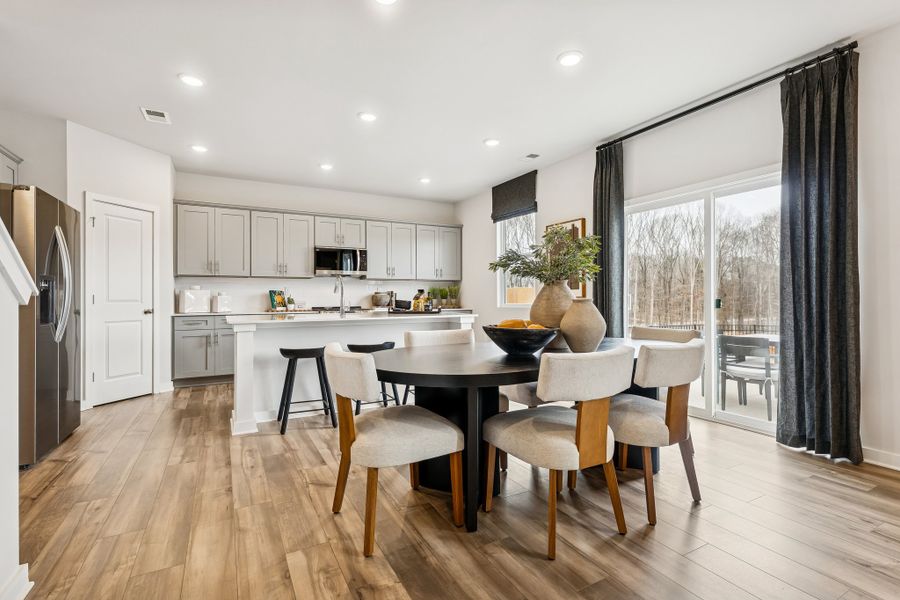 A kitchen with a dining table and chairs. A kitchen with a dining table and chairs.