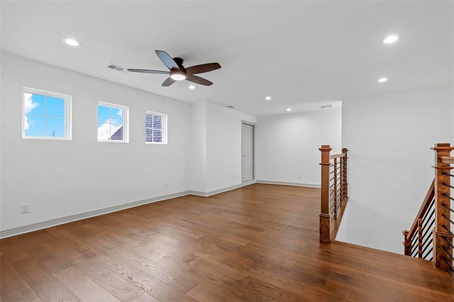 Spare room featuring hardwood / wood-style flooring and ceiling fan