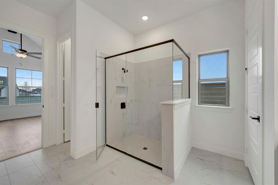 Bathroom featuring a marble finish shower, light marble finish flooring, a ceiling fan, and recessed lighting