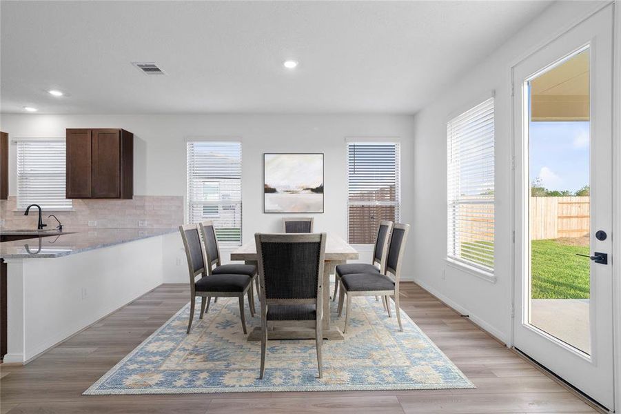 Make memories gathered around the table with your family and friends! This dining room features high ceilings, large windows with privacy blinds, and easy access to your kitchen and family room.