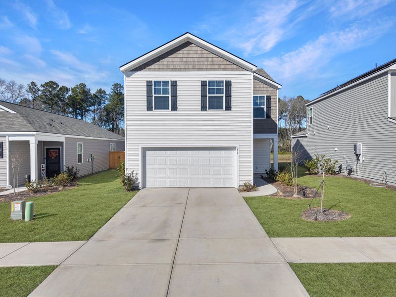 Front exterior of a new home in Pine Hills at Cane Bay, Summerville, SC, highlighting curb appeal (Image 1). Front exterior of a new home in Pine Hills at Cane Bay, Summerville, SC, highlighting curb appeal (Image 1).