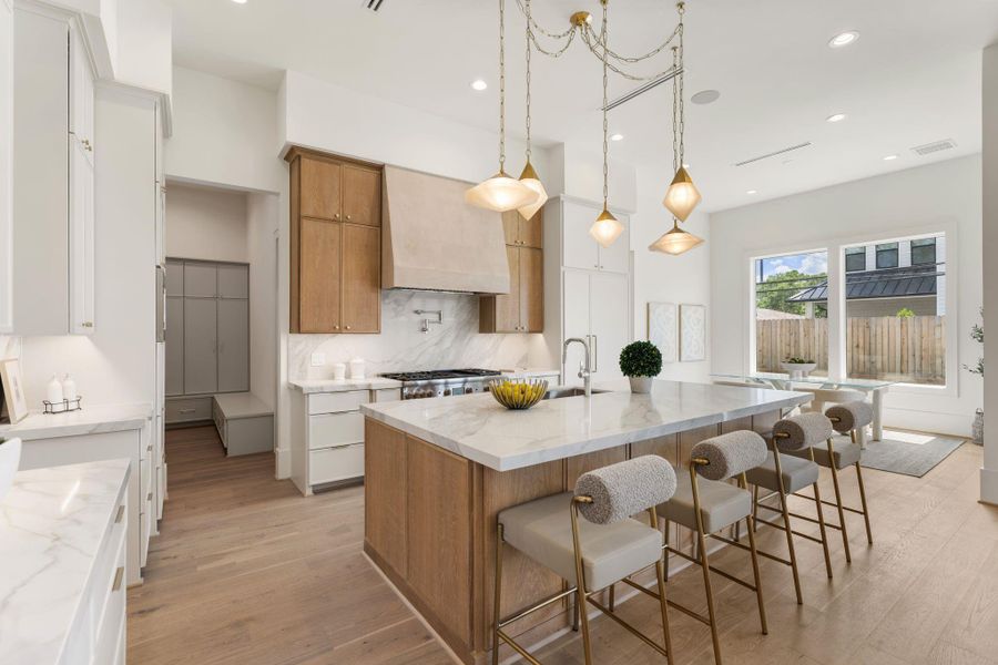 From the kitchen, the open-concept design unfolds seamlessly into the living area, highlighting the home’s natural flow, high ceilings, and cohesive material palette throughout.