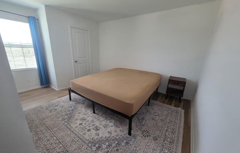 Bedroom with light wood-style flooring and baseboards Bedroom with light wood-style flooring and baseboards