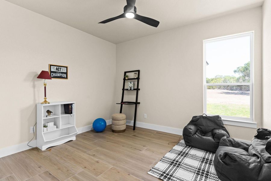 Sitting room with light wood-type flooring, baseboards, and a ceiling fan Sitting room with light wood-type flooring, baseboards, and a ceiling fan