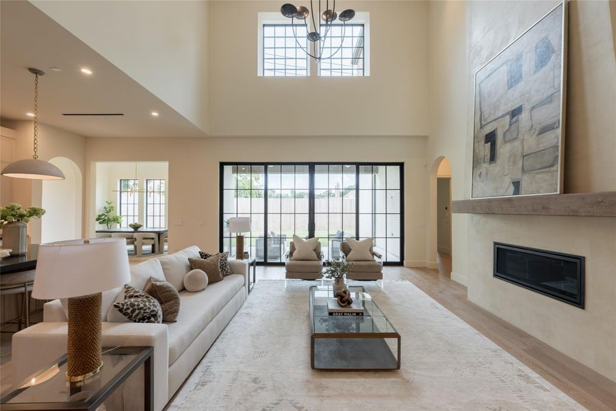 Bathed in natural light from oversized two story windows and expansive sliding iron doors, the living room offers a seamless connection to the outdoors and a stunning sense of scale. A reclaimed white oak mantel and custom lime plaster fireplace while revealing a stunning dining room. Bathed in natural light from oversized two story windows and expansive sliding iron doors, the living room offers a seamless connection to the outdoors and a stunning sense of scale. A reclaimed white oak mantel and custom lime plaster fireplace while revealing a stunning dining room.