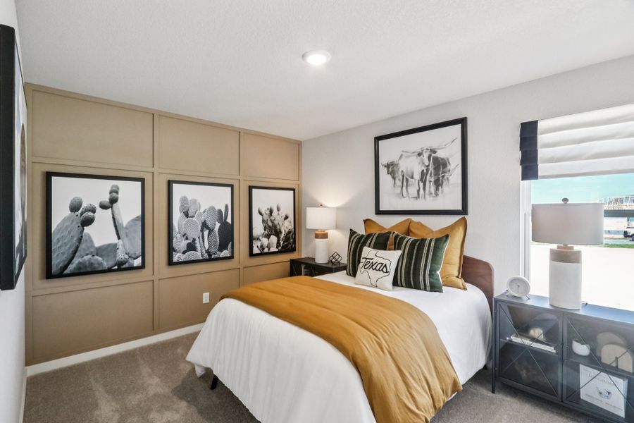 A bedroom with a bed and a window.