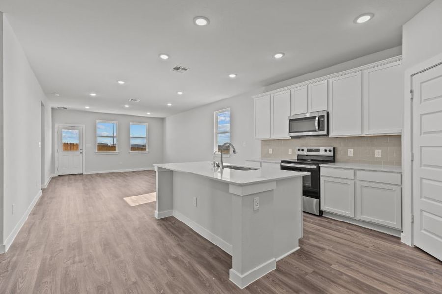 A kitchen with white cabinets.