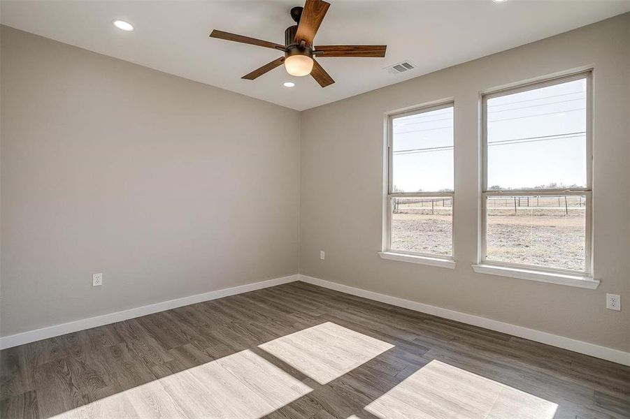 Spare room featuring dark hardwood / wood-style flooring and ceiling fan