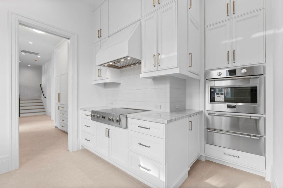 The catering kitchen features stunning stainless steel appliances like the cooktop, microwave and warming drawers The catering kitchen features stunning stainless steel appliances like the cooktop, microwave and warming drawers