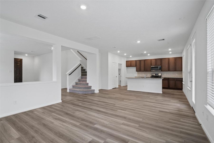 Experience seamless flow in this open-concept family room, which connects effortlessly to the kitchen/dining area, making it ideal for entertaining and everyday life.