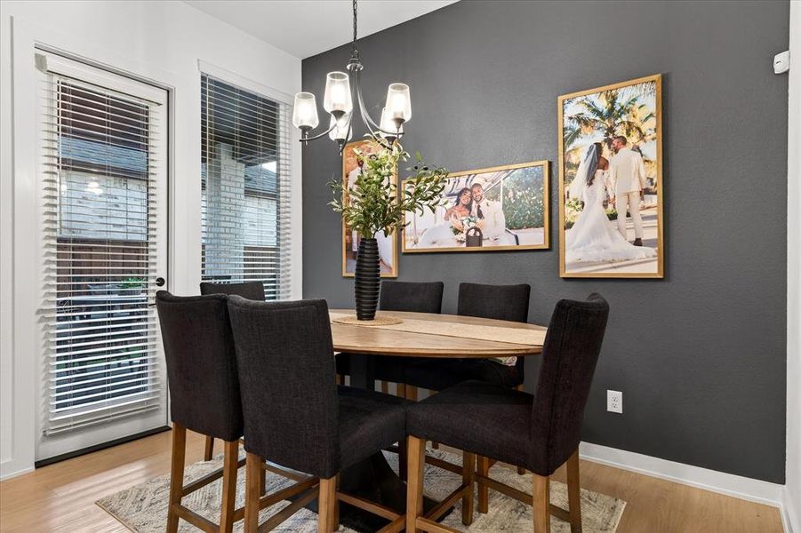 Dining space with a chandelier and light wood-type flooring Dining space with a chandelier and light wood-type flooring