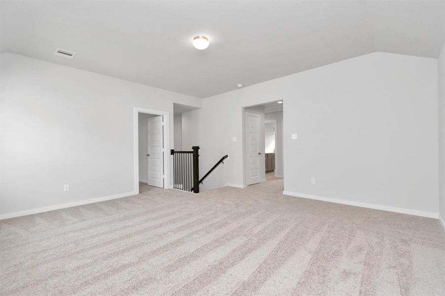 Ascend to relaxation in this fantastic game room! Ideal for both casual gatherings and adult gaming, it boasts plush carpet, lofty ceilings, custom paint, and ample windows for abundant natural light. Sample photo of completed home with similar floor plan. As-built interior colors and selections may vary.