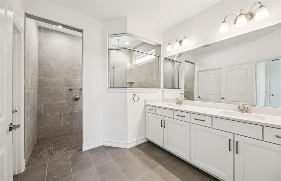 Modern owner's bath with dual vanities and a spacious shower *Real home pictured Modern owner's bath with dual vanities and a spacious shower *Real home pictured