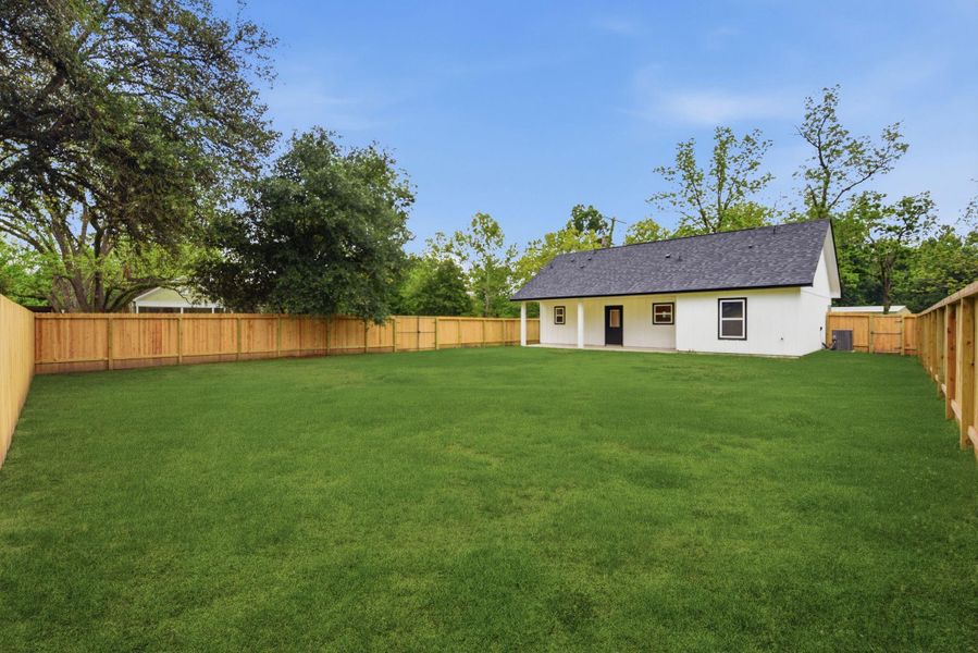 Large backyard fully fenced with covered patio and double gate