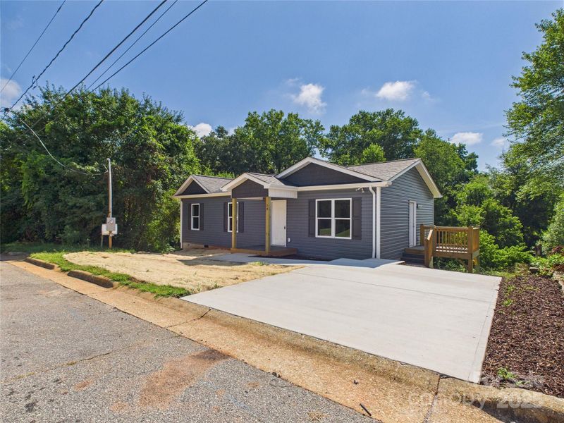 Front exterior of a new home in , Granite Falls, NC, highlighting curb appeal (Image 1).