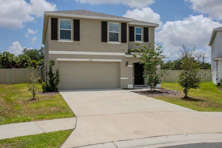 Front exterior of a new home in Evergreen, Bradenton, FL, highlighting curb appeal (Image 2). Front exterior of a new home in Evergreen, Bradenton, FL, highlighting curb appeal (Image 2).