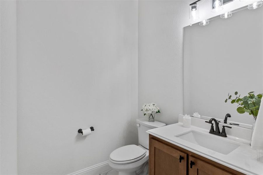 Bathroom with vanity and baseboards