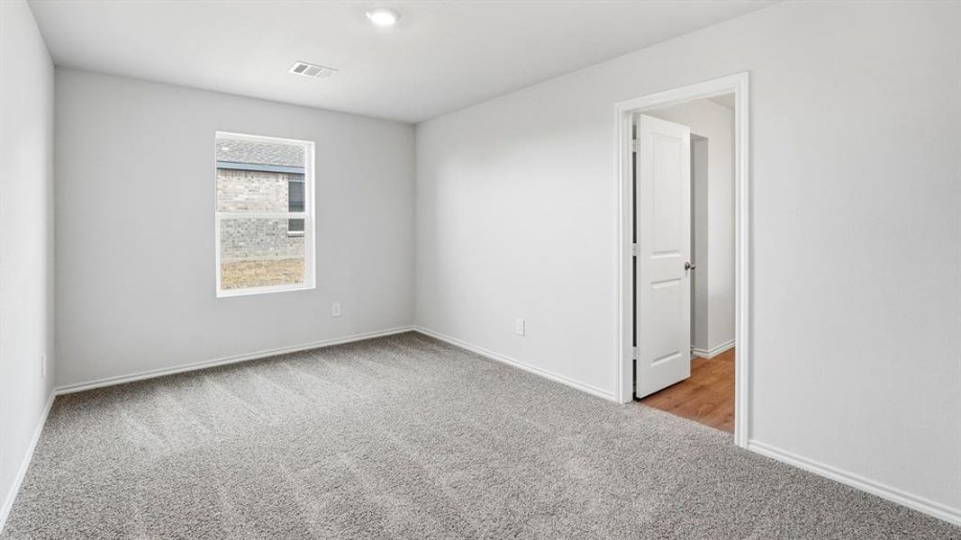 Spare room with light carpet and baseboards