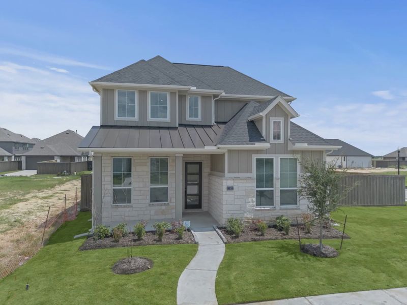 Representative exterior photo of a completed home built from the St Andrews by Chesmar Homes in Riceland Alley Loads, Mont Belvieu, TX (Image 27).
