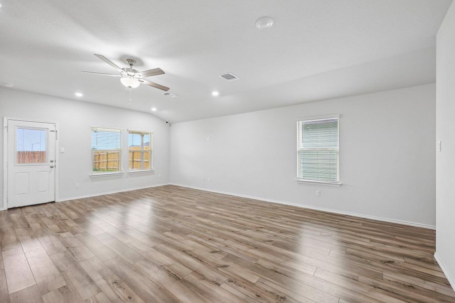 Spacious interior featuring wood-finish flooring, recessed lighting, and a ceiling fan