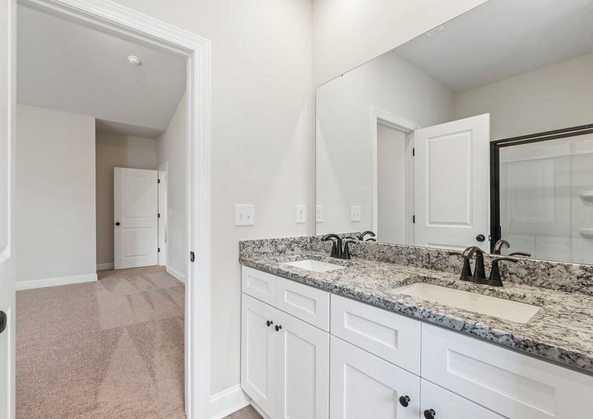 This bathroom has a glass-enclosed shower