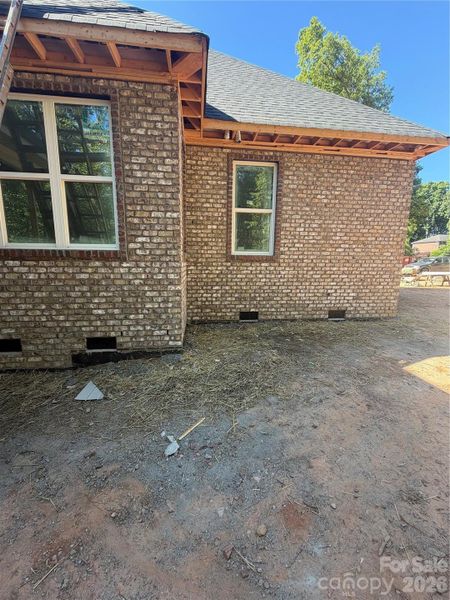 Showcasing impeccable brick work at right rear of home.