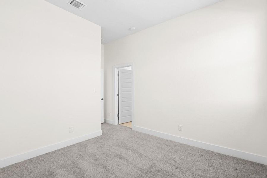 Carpeted spare room with baseboards Carpeted spare room with baseboards