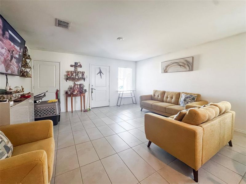 Living room with light tile patterned floors