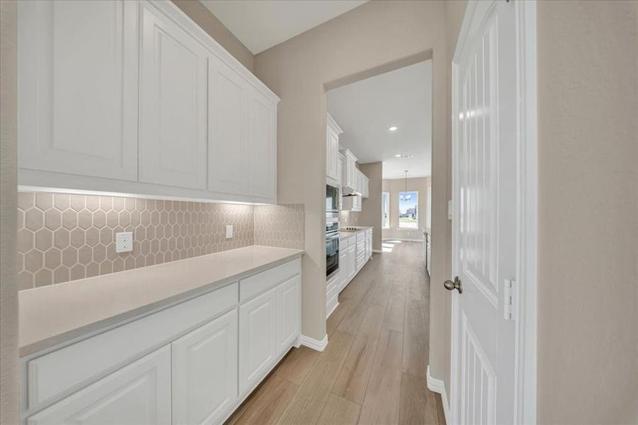 Hallway featuring light wood-type flooring and recessed lighting Hallway featuring light wood-type flooring and recessed lighting