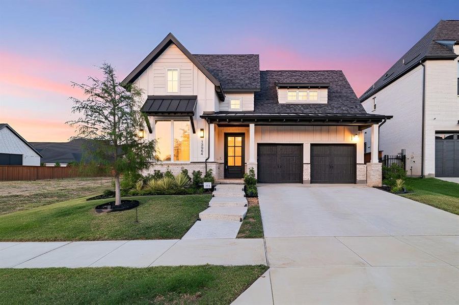 Modern farmhouse style home featuring board and batten siding, covered porch, a standing seam roof, driveway, and a shingled roof Modern farmhouse style home featuring board and batten siding, covered porch, a standing seam roof, driveway, and a shingled roof