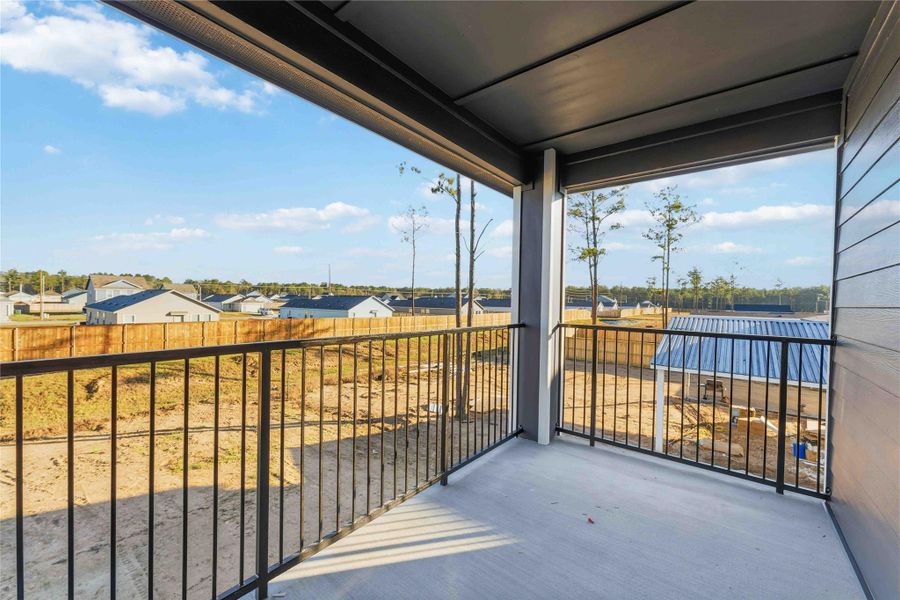 Private covered balcony off the primary suite, offering peaceful outdoor space with open neighborhood views. Ideal for morning coffee or evening relaxation, this elevated retreat provides fresh air, natural light, and a quiet escape right from your bedroom.