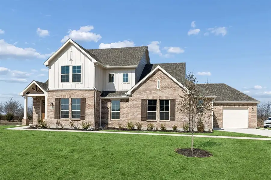 Front exterior of a new home in Ellis Ranch Estates, Waxahachie, TX, highlighting curb appeal (Image 22). Front exterior of a new home in Ellis Ranch Estates, Waxahachie, TX, highlighting curb appeal (Image 22).