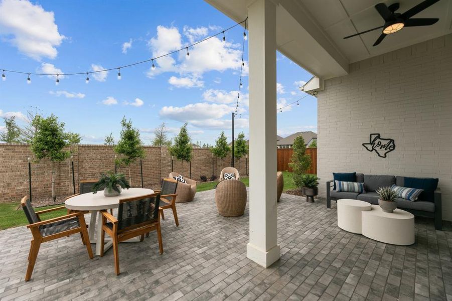 Fenced backyard featuring a ceiling fan, a patio, and outdoor lounge area Fenced backyard featuring a ceiling fan, a patio, and outdoor lounge area