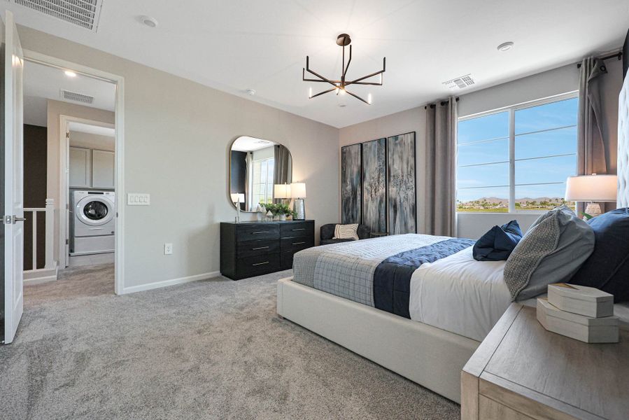 A bedroom with a bed and a mirror.