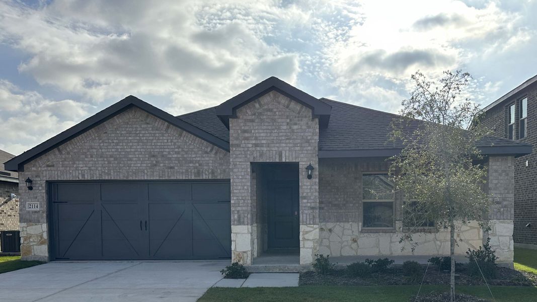 Front exterior of a new home in Cartwright Ranch, Crandall, TX, highlighting curb appeal (Image 1). Front exterior of a new home in Cartwright Ranch, Crandall, TX, highlighting curb appeal (Image 1).