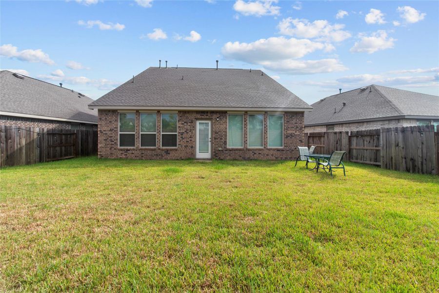 Spacious fenced backyard with a well-maintained lawn, perfect for outdoor entertaining or relaxing with family. Spacious fenced backyard with a well-maintained lawn, perfect for outdoor entertaining or relaxing with family.
