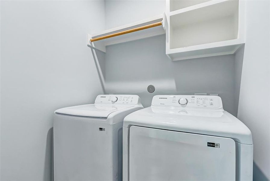 Utility room with space to hang wet clothing and storing of cleaning products.