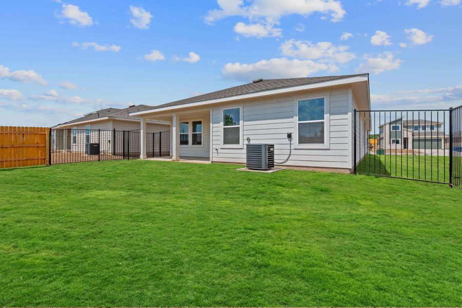 Rear view of property featuring a patio area, a fenced backyard, and roof with shingles Rear view of property featuring a patio area, a fenced backyard, and roof with shingles