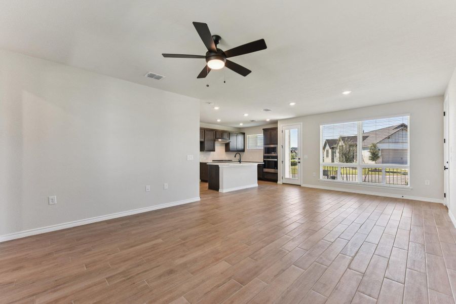 Unfurnished living room with recessed lighting, a ceiling fan, and light wood-type flooring