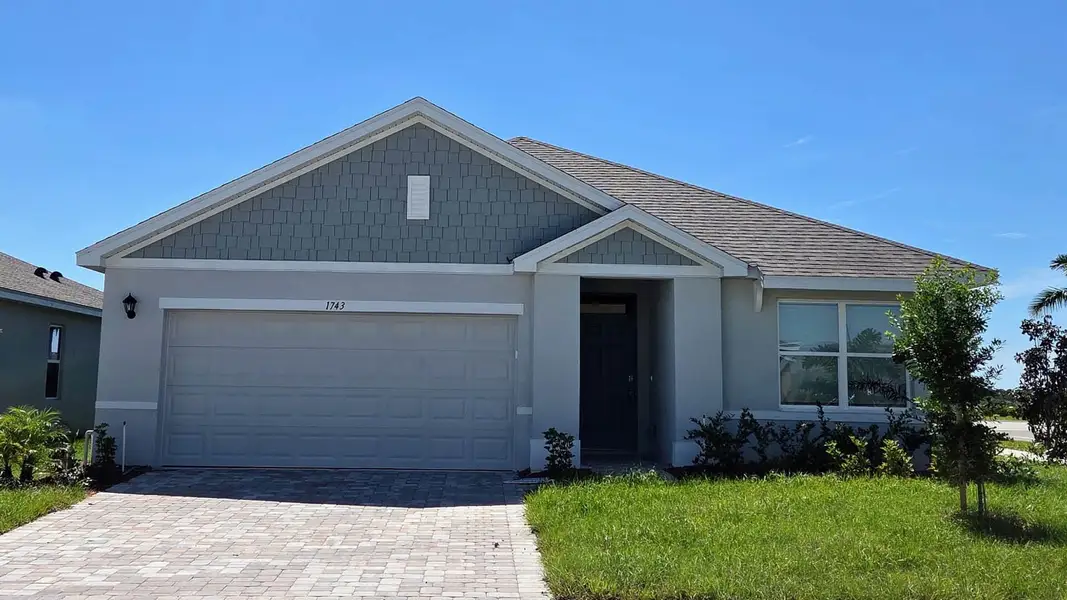 Front exterior of a new home in Cypress Bay West, Palm Bay, FL, highlighting curb appeal (Image 1). Front exterior of a new home in Cypress Bay West, Palm Bay, FL, highlighting curb appeal (Image 1).