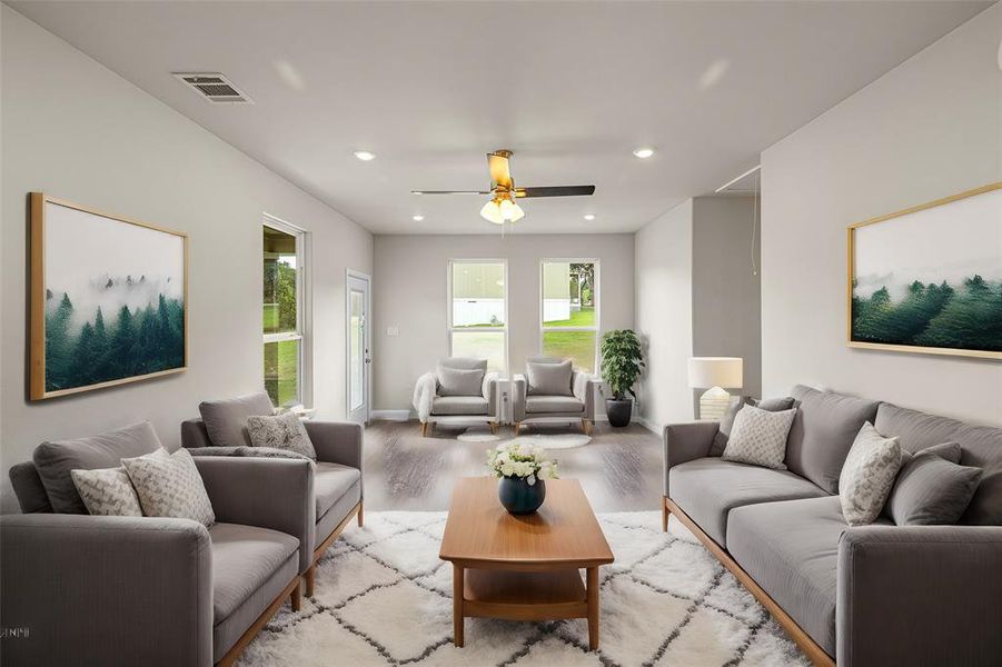 Living room with ceiling fan and light hardwood / wood-style floors