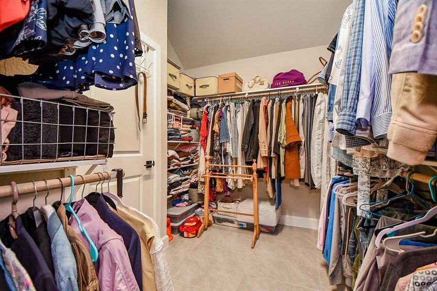Spacious walk-in closet with ample hanging space, shelving for storage, and organized compartments for clothing and accessories. Perfect for keeping everything tidy and accessible.
