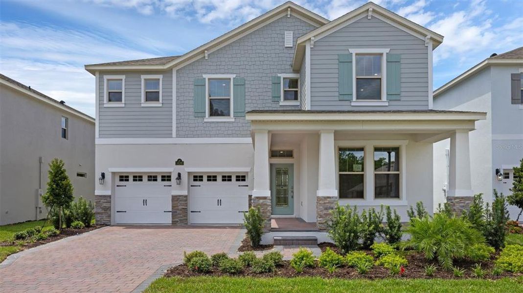 Front exterior of a new home in Waterleigh, Winter Garden, FL, highlighting curb appeal (Image 1). Front exterior of a new home in Waterleigh, Winter Garden, FL, highlighting curb appeal (Image 1).