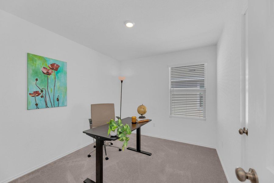 Office area with light carpet and baseboards
